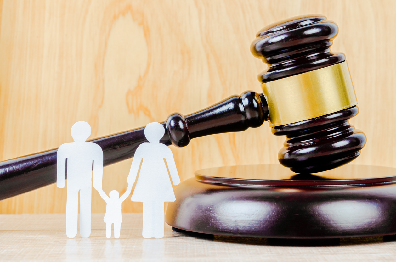 Family figure and gavel on table. | Galmiche Law Firm, P.C.